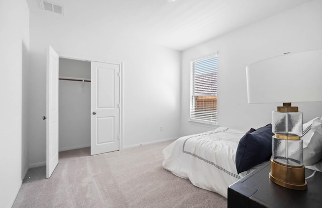 bedroom featuring a closet and light colored carpet