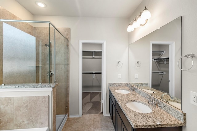 bathroom with tile patterned floors, vanity, and walk in shower