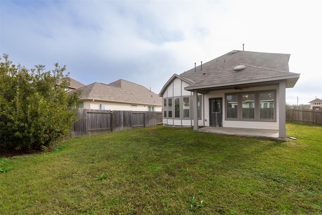 rear view of house featuring a yard and a patio