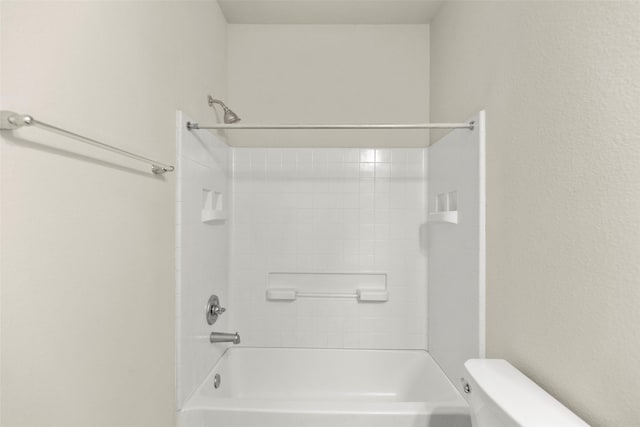 bathroom featuring bathing tub / shower combination and toilet