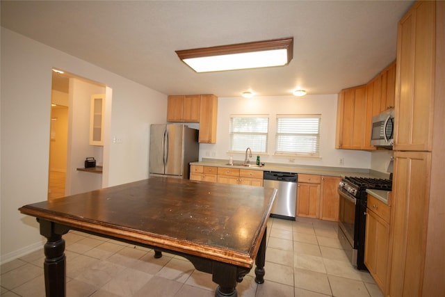 kitchen with light brown cabinetry, sink, light tile patterned flooring, and stainless steel appliances