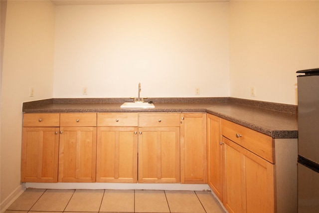 kitchen featuring sink and light tile patterned flooring