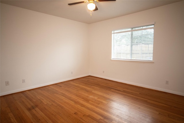 spare room with ceiling fan and wood-type flooring