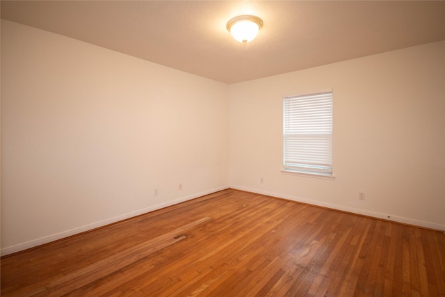 unfurnished room with hardwood / wood-style floors