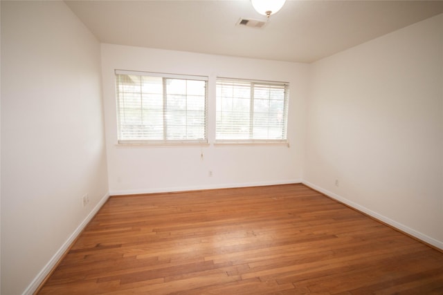 empty room with hardwood / wood-style flooring