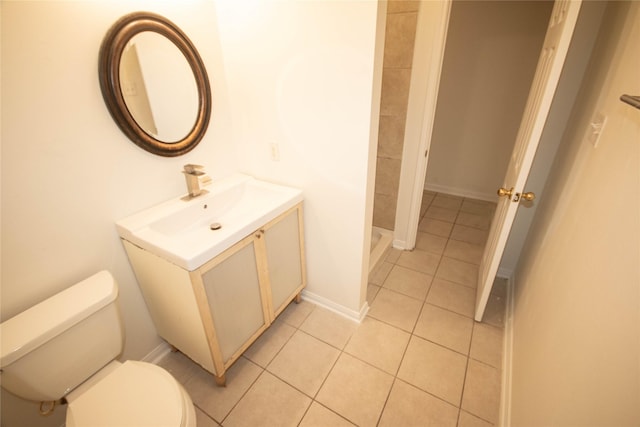 bathroom featuring a shower, tile patterned floors, vanity, and toilet