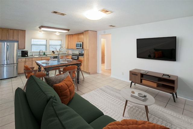 living room with light tile patterned flooring and sink