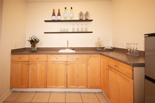 bar featuring sink and light tile patterned floors