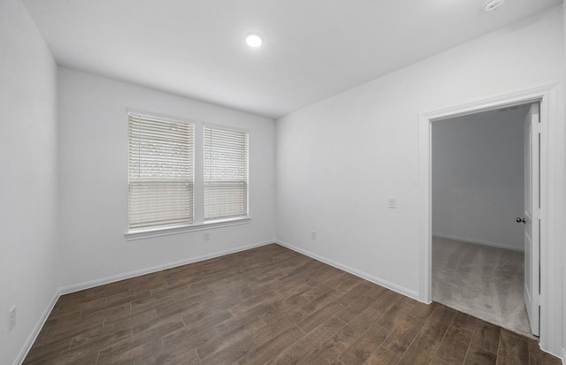 spare room with dark wood-type flooring