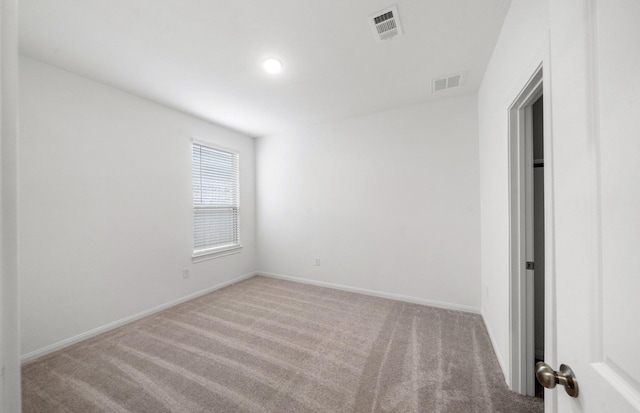 unfurnished room with light carpet