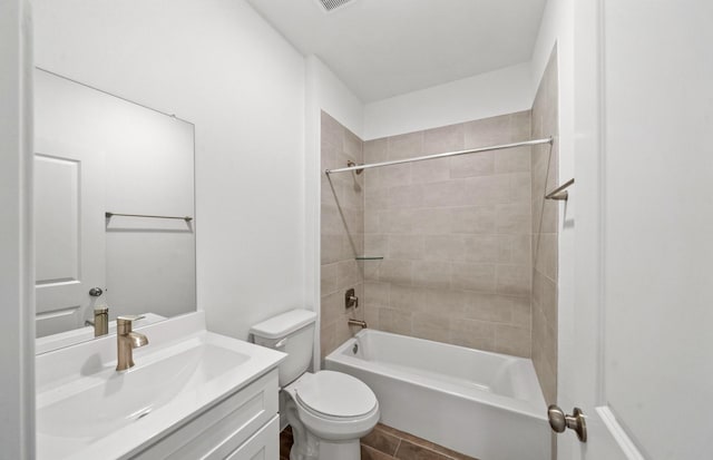 full bathroom featuring vanity, toilet, and tiled shower / bath