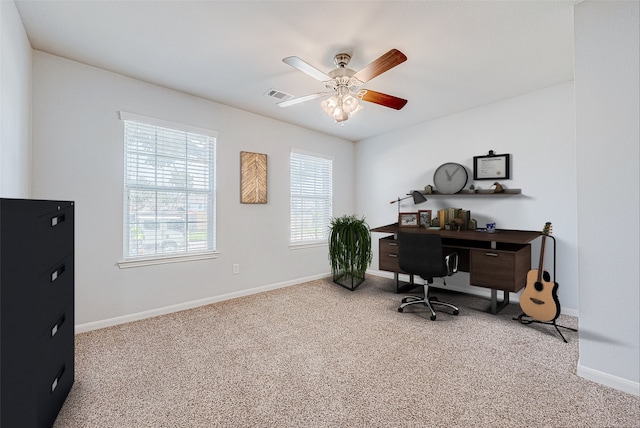 home office with ceiling fan and light carpet