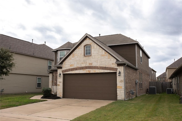 view of front of property with central AC, a front lawn, and a garage