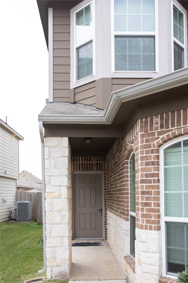 view of exterior entry with central AC unit