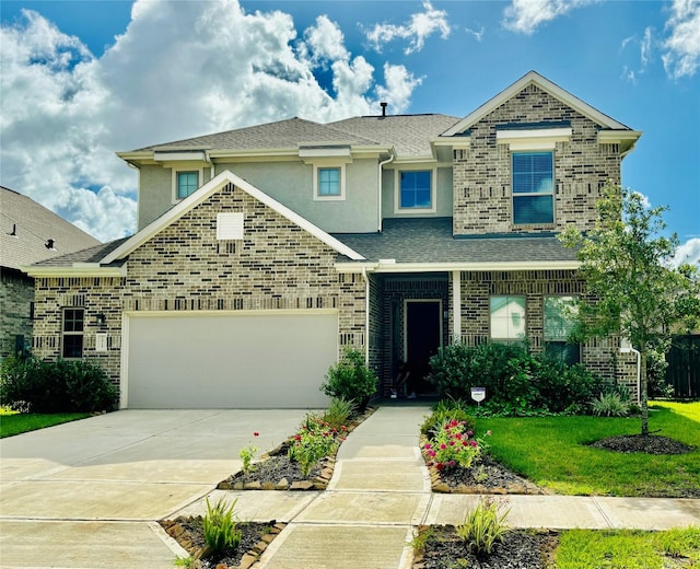 view of front of home with a front lawn and a garage