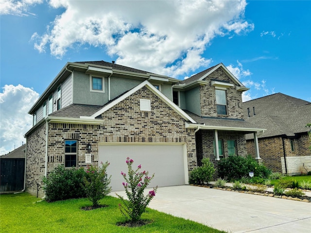 view of front of home with a garage and a front lawn