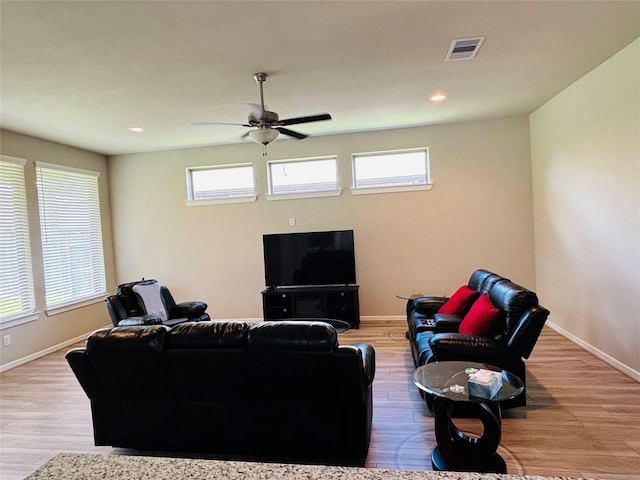 living room featuring hardwood / wood-style floors, plenty of natural light, and ceiling fan