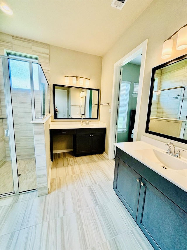 bathroom featuring vanity and an enclosed shower