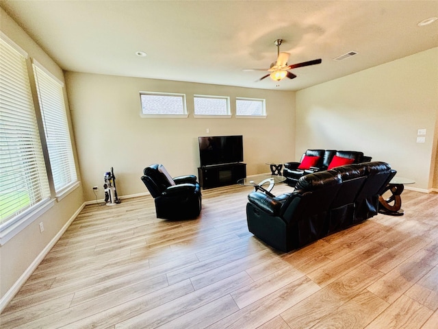 living room featuring ceiling fan and light wood-type flooring