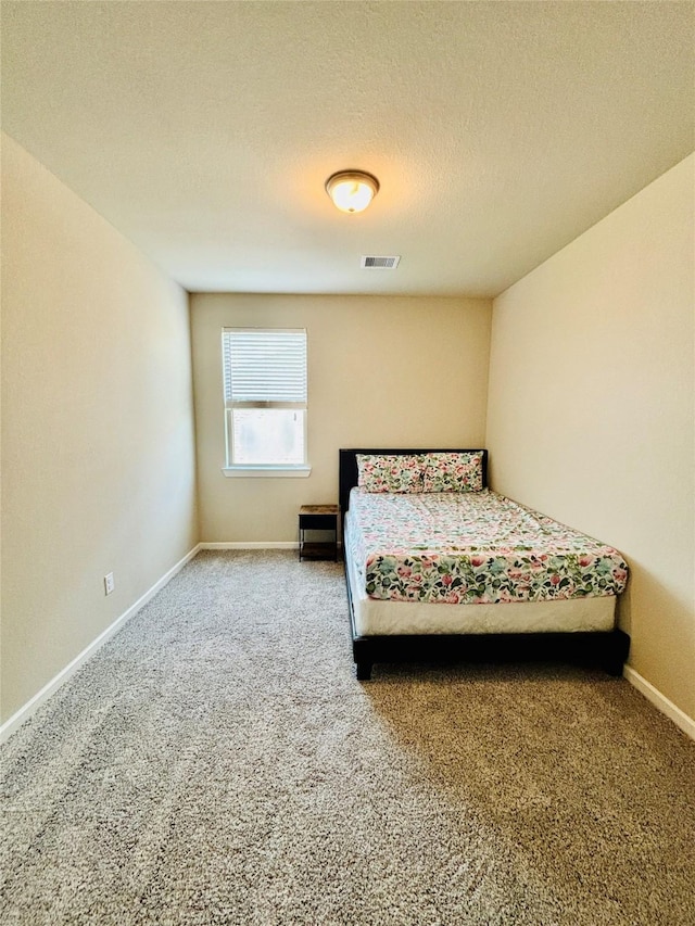 carpeted bedroom with a textured ceiling