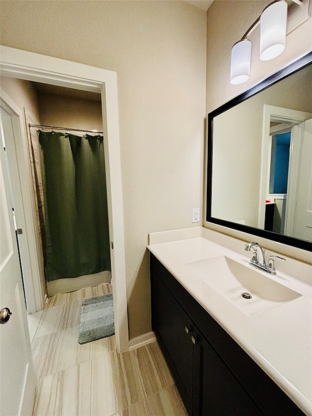 bathroom with vanity and curtained shower