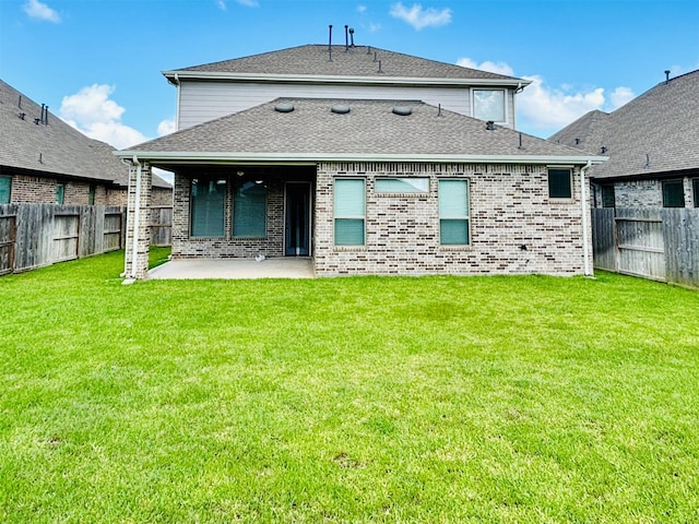 back of property with a patio and a lawn