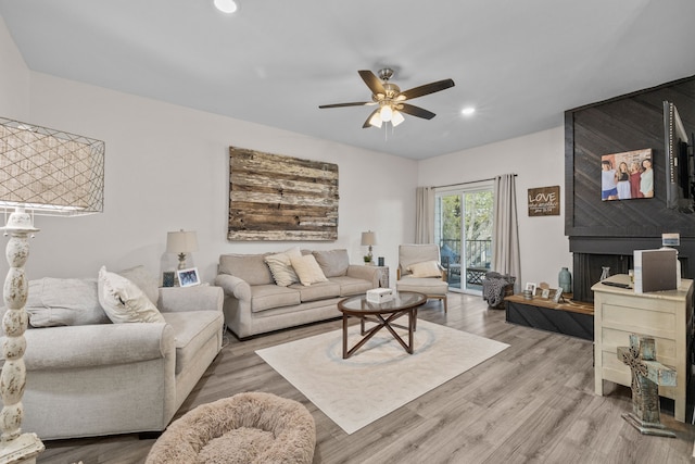 living room with hardwood / wood-style flooring and ceiling fan