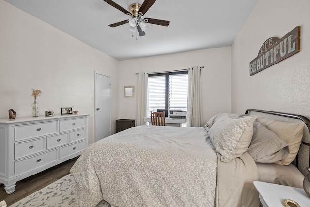 bedroom featuring ceiling fan and dark wood-type flooring