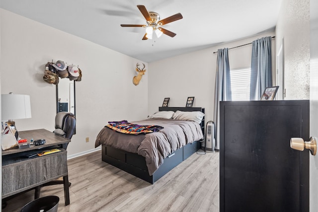 bedroom with ceiling fan and light hardwood / wood-style floors