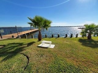 exterior space with a water view and a lawn