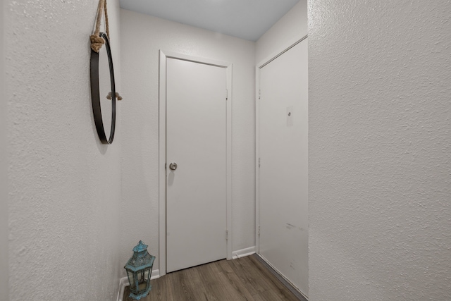 hallway with dark wood-type flooring