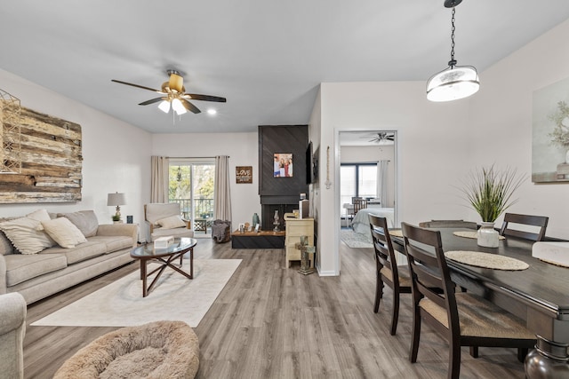 living room with light hardwood / wood-style floors and ceiling fan