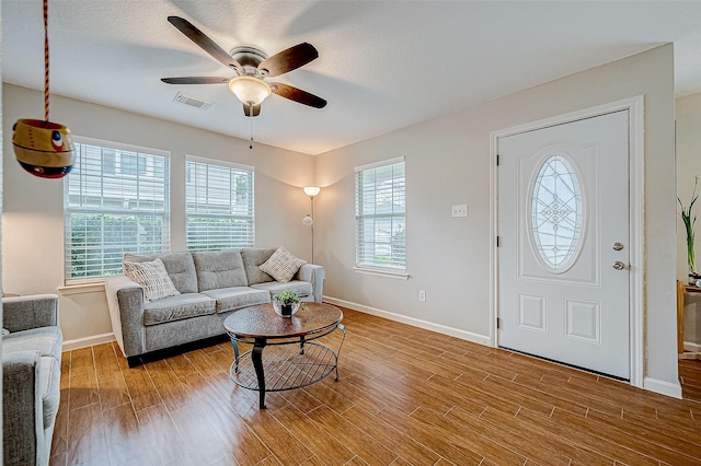 living room featuring ceiling fan and light hardwood / wood-style flooring