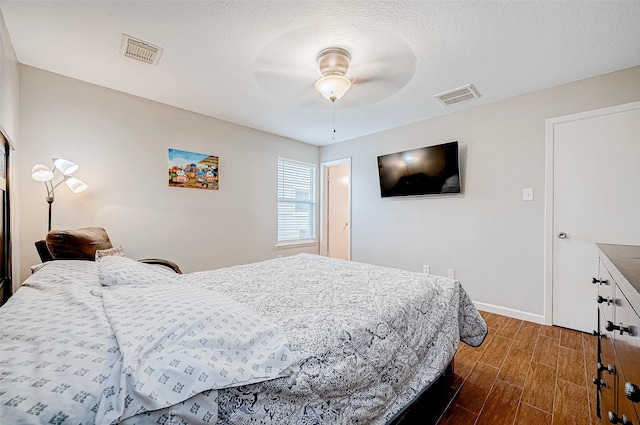 bedroom featuring ceiling fan and a textured ceiling