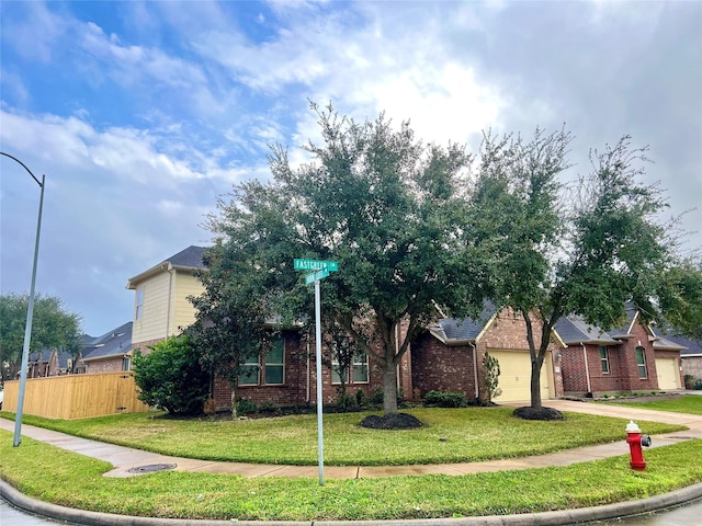 view of front of home with a front yard and a garage