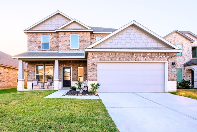 craftsman-style house with a garage, covered porch, and a front lawn