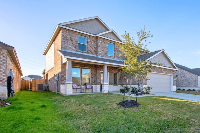 craftsman house featuring cooling unit, a garage, covered porch, and a front lawn