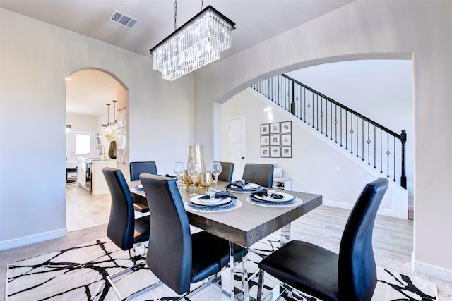 carpeted dining space featuring a chandelier