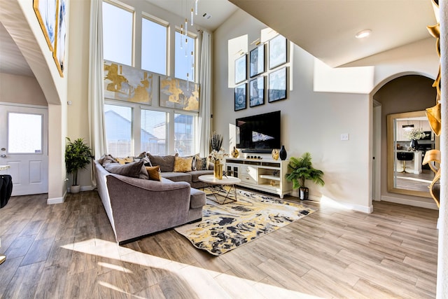 living room featuring a towering ceiling