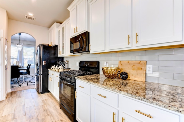 kitchen featuring backsplash, black appliances, white cabinets, light hardwood / wood-style flooring, and light stone countertops