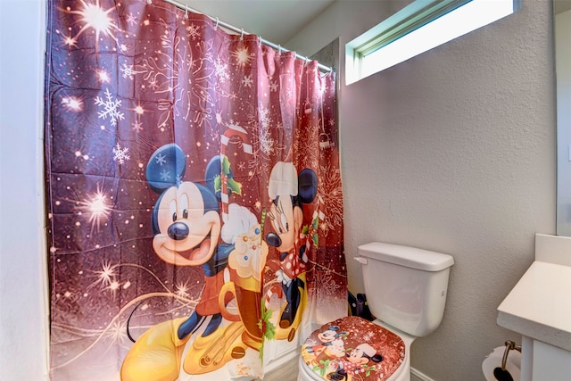 bathroom with vanity, toilet, and walk in shower