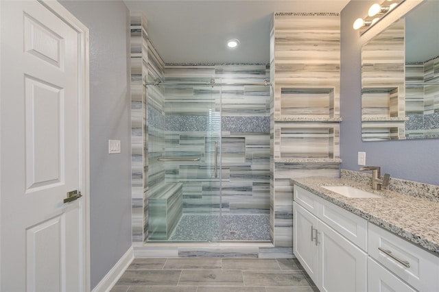 bathroom featuring vanity and a shower with shower door