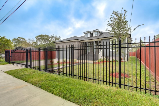 view of gate with a yard