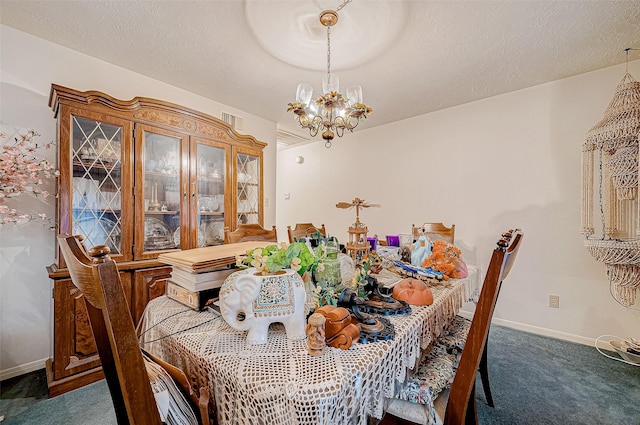 dining area featuring dark colored carpet, a textured ceiling, and a chandelier