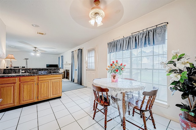 dining space featuring sink and light tile patterned flooring