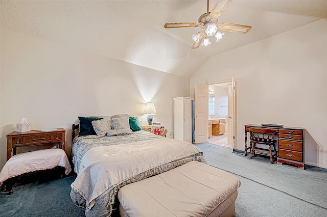 carpeted bedroom with a textured ceiling, ensuite bath, vaulted ceiling, and ceiling fan