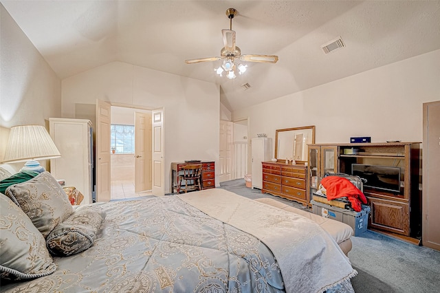 carpeted bedroom featuring ceiling fan, lofted ceiling, and connected bathroom