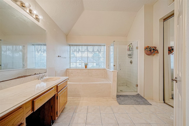 bathroom featuring vanity, vaulted ceiling, tile patterned flooring, a textured ceiling, and independent shower and bath