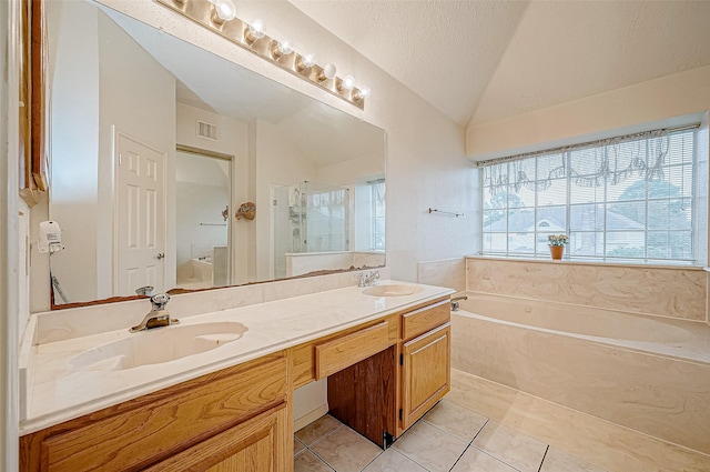 bathroom with tile patterned floors, lofted ceiling, a textured ceiling, vanity, and independent shower and bath