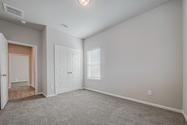 unfurnished bedroom featuring carpet and a closet